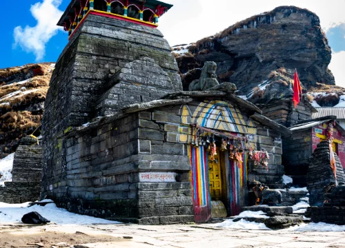 traditional-building-by-mountains-against-sky-winter